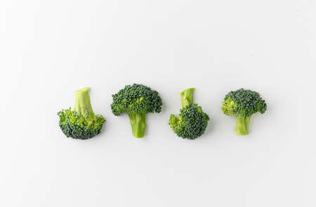 Fresh Healthy vegetables and food. Raw broccoli cut into small pieces and put on white table background.の写真素材