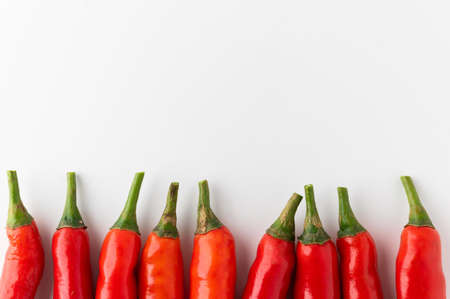 Raw green bell pepper cut into small pieces. Healthy vegetables and food on isolated white...