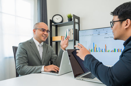 Two businessmen are discussing various business topics. A team of business people chatting in an...