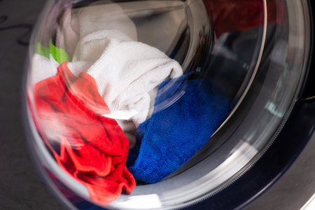 Washing machines and colorful fabrics The washing machine is running set in the house.の写真素材
