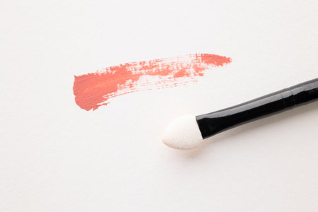 Top view cosmetics makeup for female on the white table background with Different brush types.