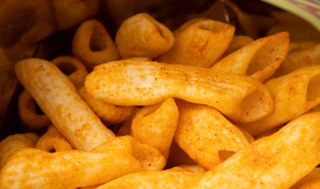 Crispy penne pasta shaped salty. Fast food or junk food snacks unhealthy concept.