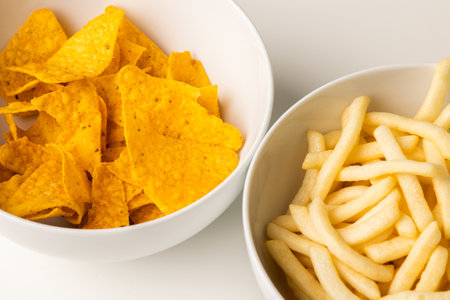 Crispy mexican nachos chips and French fries salty.Snacks Fast food or junk food snacks unhealthy...