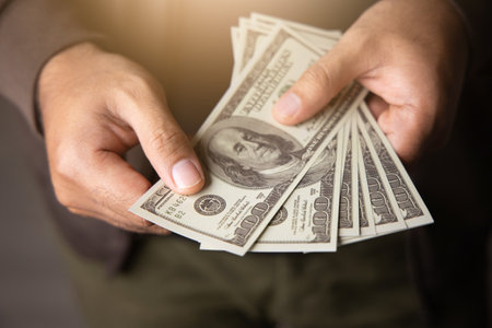 Close up male hand Counting money us dollar. Financial business concept.の写真素材