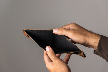 Close up male hand open the empty wallet.There is no money in wallet. Financial business concept.
