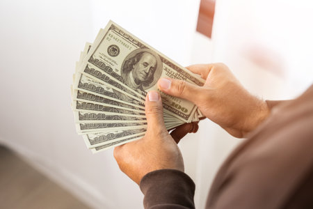 Close up male hand Counting money us dollar. Financial business concept.