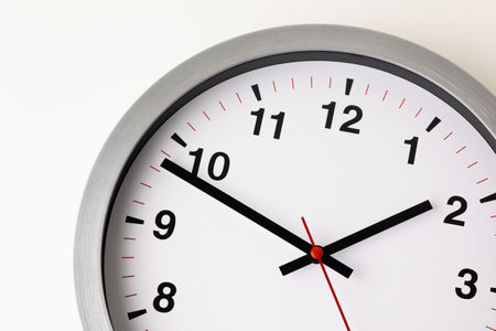 Large white clock, black numbers, red needle Set a timer on the white table