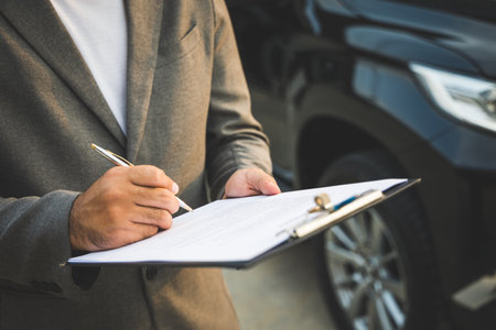 A young business man signs a luxury car leasing contract And sign a car insurance purchase contract on the documents according to the agreementの写真素材
