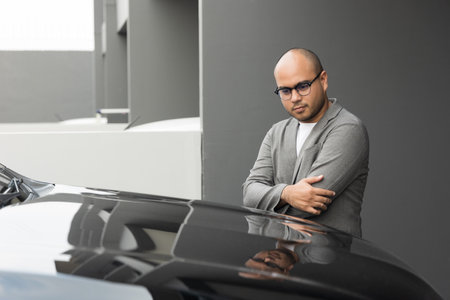 Young handsome asian businessman getting the new car. He so proud and excited. Buy or rent car concept.の写真素材