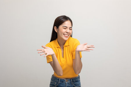 Excited asian woman shout out loud wow with hands on isolated background. Happy shocked face female...