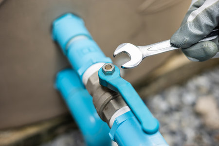 Male Plumber worker installation pipe system use wrench with the water tap. Plumbing checking...