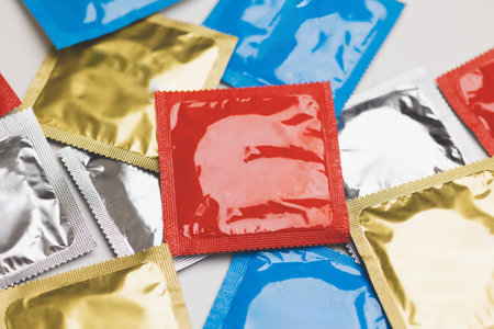 Colorful lot of condom put on the table. Campaign for safe sex and contraception.