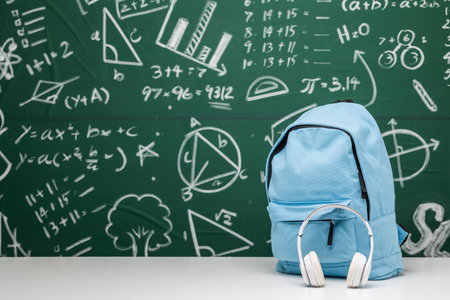 Back to school background. Stationery Supplies in the school bag. Banner design education On chalkboard with the Mathematical formula.の写真素材