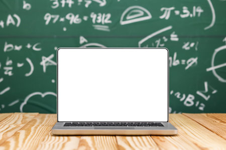 Education background concept. Laptop with blank screen on Mathematical formula chalkboard. Banner design copy space.の写真素材