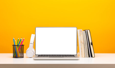 Education background concept. Laptop with blank screen on Yellow background. Banner design copy...