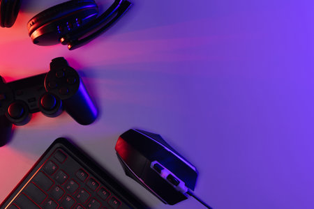 Accessory gaming keyboard joystick mouse headphone with blank space. Gadget for gamer playing video...