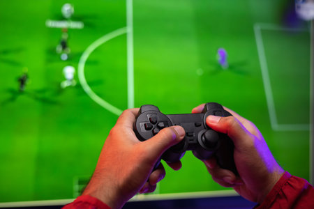 Rear view young Player video computer pc. Young man sitting on chair in game station holding...