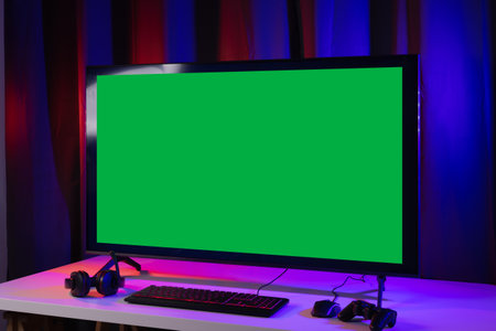 Blank screen display computer pc with gaming gear joystick mouse keyboard mouse. Gamer gadget background in game station.の写真素材