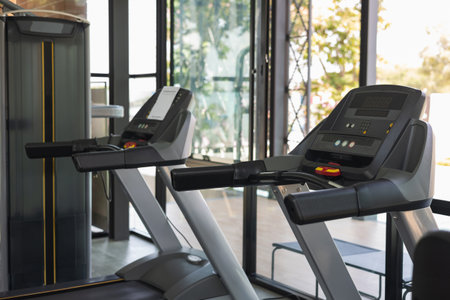 Indoor modern sport club has treadmill and weight training equipment. Fitness places for cardio...