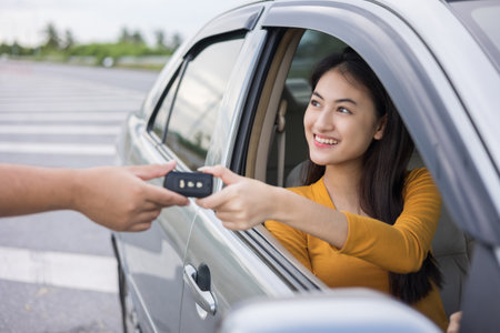 Young beautiful asian women buying new car. she very happy and excited. Sit in and getting car key....