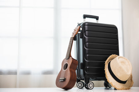 Black plastic trolley bag in the house. Travel Preparing suitcase for summer vacation trip. Travel accessories luggage.の写真素材