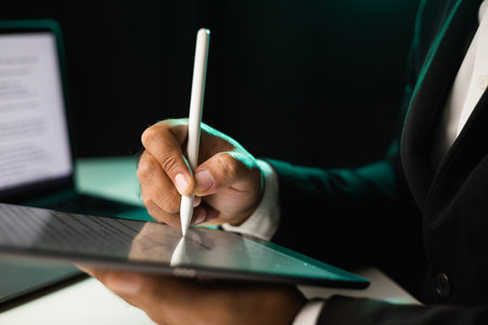 Close up businessman hand electronic Signature on Tablet by Stylus. Write business agreement of contract. Man signing contract on tablet. Business and technology concept.の写真素材