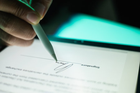 Close up businessman hand electronic Signature on Tablet by Stylus. Write business agreement of contract. Man signing contract on tablet. Business and technology concept.の写真素材