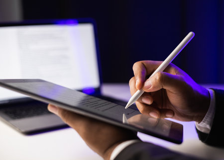 Close up businessman hand electronic Signature on Tablet by Stylus. Write business agreement of contract. Man signing contract on tablet. Business and technology concept.の写真素材