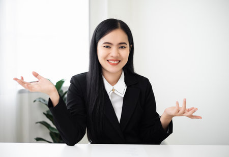 Business asian woman blogger vlogger influencer sit at home speaking looking at camera talking make video conference call record lifestyle blog vlog doing video chat at home concept, webcam view.の写真素材