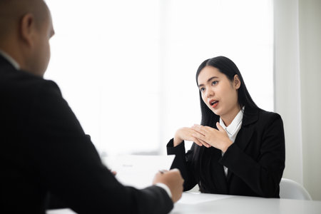 Business woman  to greet a HR staff before a job interview to apply for a job. Happy woman seeker or insurance broker presenting a business deal. Smart asian woman sending resume.の写真素材