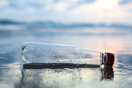 Plastic water bottles are left on the beach as waste polluting nature. Plastic is hard to degrade. destroy the ecosystem. World environment day concept.の写真素材