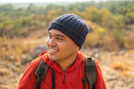 Smiling Young asian man challenge for purpose with hiking on rocky mountains outdoor. Man traveler...