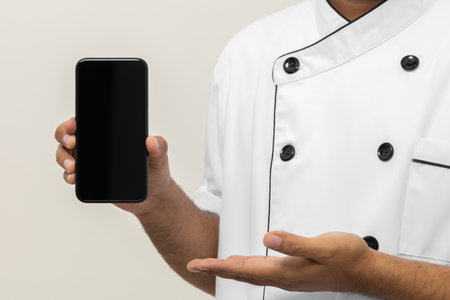 Close up male hands chef showing empty screen cellphone to choose various delicious dish menu good taste for customer order. Online smartphone delivery food buying variety of dishの写真素材