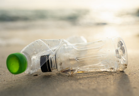 Plastic water bottles are left on the beach as waste polluting nature. Plastic is hard to degrade....