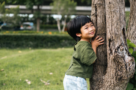Happy moment of little child playing in home garden. Asian boy love and caring the environment. The smile of a kid with a beautiful nature. Ecology concept.の写真素材