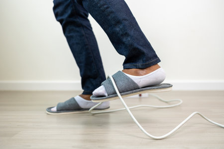 A man stumbles upon a cluttered wire lying on the ground. Stumbled until the head hit the ground. Accident at home It is because of carelessness and clumsiness electric shockの写真素材