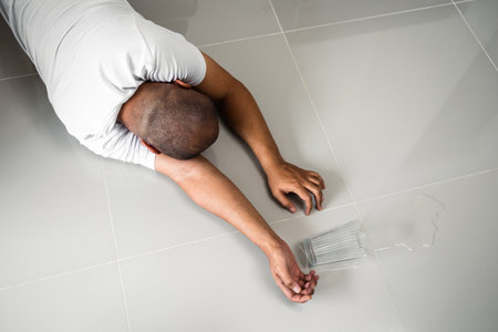 An elderly man fainted. Falling asleep on the floor alone unassisted. If you have an accident at home you must have insurance and go to the hospital.の写真素材