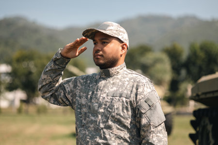 Asian man special forces soldier saluting standing against on the field Mission. Commander Army soldier military defender of the nation in uniform standing near battle tank while state of war.の写真素材