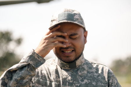 Stressed depressed crying lose war Asian man special forces soldier against on the field Mission....