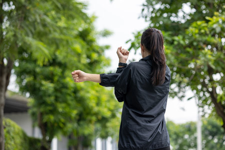 Beautiful asian woman wearing sportswear warming up before running. Confident and powerful woman stretching before Workout exercise in the morning. Healthy and active lifestyle concept.の写真素材