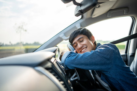 Young handsome asian man getting the new car. He hugged his car and was very happy touching detail interior . Buy or rent car concept.の写真素材