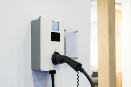 Ev car Electric car charging on parking lot. Power cable supply plugged at Electric car charging...