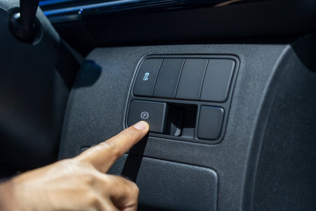 Finger pushing button in car. Car safety technology function.