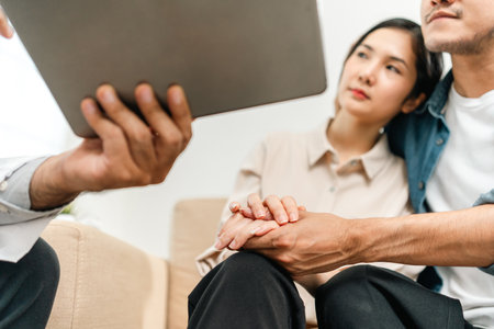 Asian family discussing fertility with a pediatrician. Young couple patients in fertility clinic...