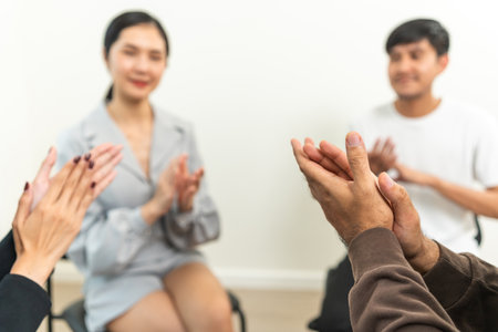 Applauding in group therapy session. Support of counselor diverse people friend group help motivation. Diverse young people in support friends sharing success storyの写真素材