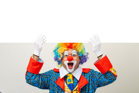 Mr Clown. Portrait of Funny face Clown man in colorful uniform standing holding copy space. Happy expression male bozo in various pose with frame mockup blank space on isolated background.の写真素材