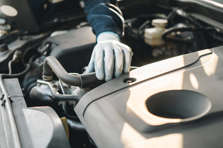 Professional car mechanic maintenance vehicle. The mechanic opens the front of the car. Checking the...