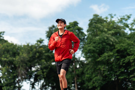 Attractive Young indian man wearing sportswear running on track at sport stadium. Asian Fit man...