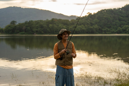 Enjoy moment of Handsome man fishing as a leisure activity during his vacation at the lake on...