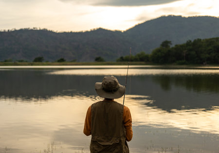 Enjoy moment of Handsome man fishing as a leisure activity during his vacation at the lake on...